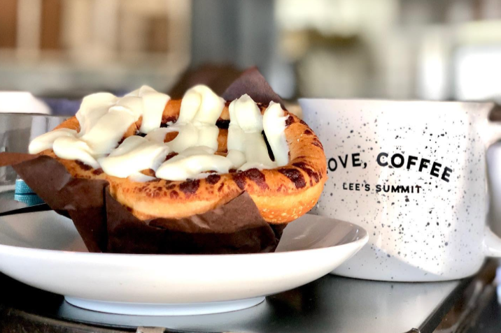 image of a baked pastry with a white speckled coffee cup that says love coffee lee's summit